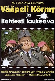 Vääpeli Körmy ja kahtesti laukeava Banda sonora (1997) cobrir